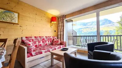 a living room with a couch and a balcony at Résidence Les Pleiades - Appartement spacieux et lumineux · Centre station · Balcon · Parking couvert MAE-7355 in Flaine