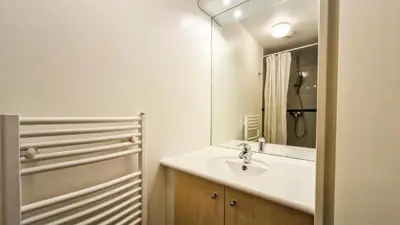 a white bathroom with a sink and a mirror at Résidence Les Pleiades - Appartement spacieux · Centre station · Balcon · Parking couvert MAE-7356 in Flaine