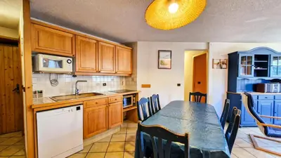 a kitchen with a table and a dining room at Résidence Arche - Appartement spacieux · Centre station · Balcon MAE-7358 in Flaine