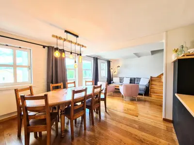 a dining room and living room with a table and chairs at Résidence Hameau - Chalet spacieux · Poêle à bois · WIFI gratuit et illimité · Garage MAE-7359 in Flaine