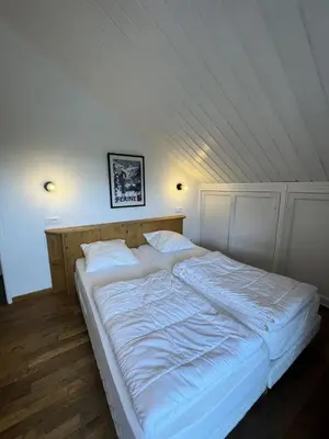 a large white bed in a room with a ceiling at Résidence Hameau - Chalet spacieux · Poêle à bois · WIFI gratuit et illimité · Garage MAE-7359 in Flaine