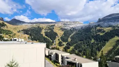 a white building with black balconies on the side of it at Résidence Doris - Appartement rénové · Centre station · Balcon MAE-7363 in Flaine