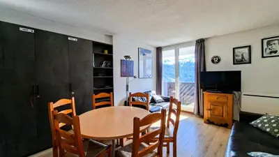 a kitchen with white cabinets and a sink and a stove at Résidence Doris - Appartement rénové · Centre station · Balcon MAE-7363 in Flaine