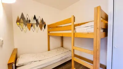 a bedroom with a bed and a large window at Résidence Les Pleiades - Appartement confortable avec cabine · Centre station · Balcon · Parking couvert MAE-7366 in Flaine