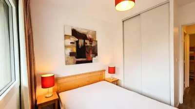 a hallway with a bathroom with a poster of a woman at Résidence Les Pleiades - Appartement confortable avec cabine · Centre station · Balcon · Parking couvert MAE-7366 in Flaine