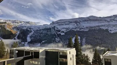a building with a view of a snow covered mountain at Résidence Gemeaux - Appartement confortable · Centre station · Balcon MAE-7369 in Flaine