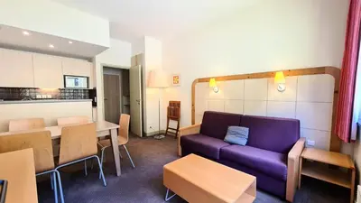 a living room with a purple couch and a table at Residence De La Foret - Appartement confortable · Proche des pistes · Casier à ski MAE-7372 in Flaine