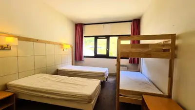 a room with two bunk beds and a window at Residence De La Foret - Appartement confortable · Proche des pistes · Casier à ski MAE-7372 in Flaine