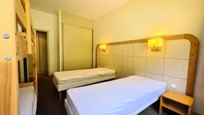 a small room with two beds and a mirror at Residence De La Foret - Appartement confortable · Proche des pistes · Casier à ski MAE-7372 in Flaine