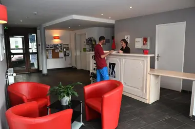 a man and a woman standing at a counter at Résidence Les Pleiades - Appartement lumineux · Centre station · Balcon · Parking couvert MAE-7373 in Flaine
