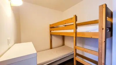 a bunk bed room with two bunk beds and a ladder at Résidence Les Pleiades - Appartement lumineux · Centre station · Balcon · Parking couvert MAE-7373 in Flaine