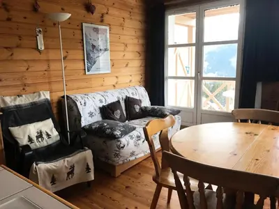 a living room with a couch and a table at Résidence Chateaux De Crans - Appartement confortable · Balcon MAE-7375 in Flaine