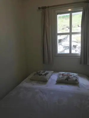 a bedroom with a bed with two pillows and a window at Résidence Chateaux De Crans - Appartement confortable · Balcon MAE-7375 in Flaine