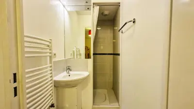 a small bathroom with a sink and a shower at Résidence Les Pleiades - Appartement lumineux avec balcon · Centre station · Parking couvert MAE-7379 in Flaine