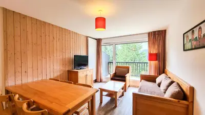a living room with a table and a couch at Résidence Les Pleiades - Appartement spacieux · Centre station · Parking couvert · Balcon MAE-7381 in Flaine