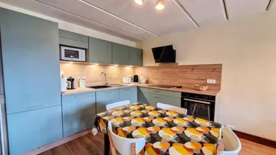 a kitchen with a table and chairs in a room at Résidence Betelgeuse - Appartement rénové · Entre pistes et commerces · Balcon MAE-7382 in Flaine