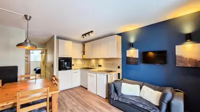 a living room and kitchen with a couch and a table at Résidence Castor - Appartement confortable · Proche des pistes · Balcon MAE-7387 in Flaine