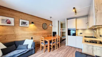 a kitchen and living room with a wooden wall at Résidence Castor - Appartement confortable · Proche des pistes · Balcon MAE-7387 in Flaine