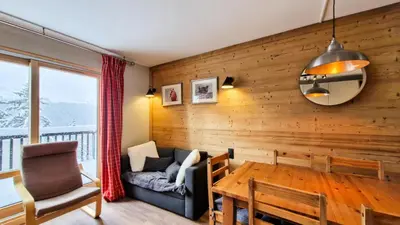 a living room with wooden walls and a table and a couch at Résidence Castor - Appartement confortable · Proche des pistes · Balcon MAE-7387 in Flaine