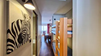 a hallway leading to a room with bunk beds and a room with a zebra at Résidence Castor - Appartement confortable · Proche des pistes · Balcon MAE-7387 in Flaine