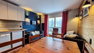 a kitchen and living room with a couch and a table at Résidence Castor - Appartement confortable · Proche des pistes · Balcon MAE-7387 in Flaine
