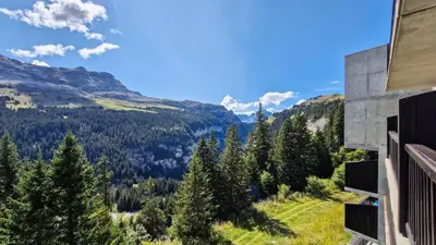 a view of the mountains from the balcony of a house at Résidence Les Pleiades - Appartement lumineux · Centre station · Balcon MAE-7393 in Flaine