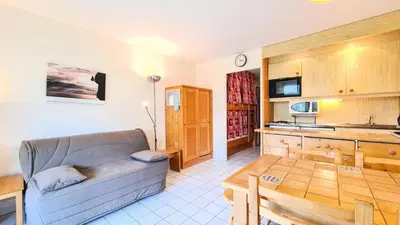a living room with a couch and a table at Résidence Castor - Studio rénové avec casier à ski · Proche des pistes · Balcon MAE-7394 in Flaine