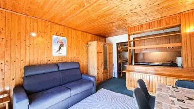 a living room with a couch and a table at Résidence Andromede - Studio confortable · Entre pistes et commerces · Balcon MAE-7395 in Flaine