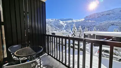 a balcony with a table and a view of a mountain at Résidence Andromede - Studio confortable · Entre pistes et commerces · Balcon MAE-7395 in Flaine