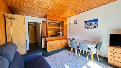 a living room with a table and chairs at Résidence Andromede - Studio confortable · Entre pistes et commerces · Balcon MAE-7395 in Flaine