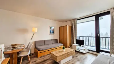a living room with a couch and a table at Résidence Vega - Studio lumineux · Proche des pistes et des commerces · Balcon MAE-7400 in Flaine