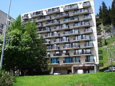 an apartment building on the side of a hill at Résidence Vega - Studio lumineux · Proche des pistes et des commerces · Balcon MAE-7400 in Flaine