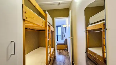 a room with two bunk beds and a hallway at Résidence Vega - Studio lumineux · Proche des pistes et des commerces · Balcon MAE-7400 in Flaine