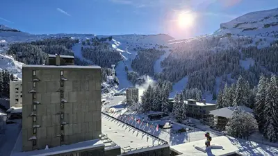 a view of a snow covered mountain with a building at Résidence Vega - Studio lumineux · Proche des pistes et des commerces · Balcon MAE-7400 in Flaine