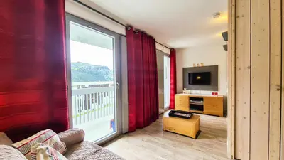 a living room with a large window and a television at Résidence La Petite Ourse - Studio neuf · Centre station · Balcon MAE-7402 in Flaine