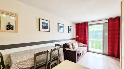 a bedroom with a bed and a couch and a window at Résidence La Petite Ourse - Studio neuf · Centre station · Balcon MAE-7402 in Flaine