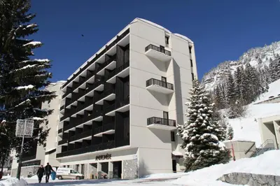 a building in the snow with a christmas tree at Résidence Andromede - Studio lumineux avec casier à ski · Proche des pistes · Balcon MAE-7403 in Flaine