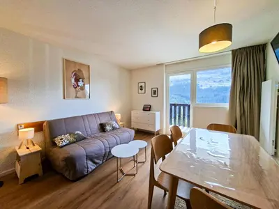 a living room with a couch and a table at Résidence Gemeaux - Studio confortable · Centre station · Balcon MAE-7410 in Flaine