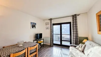 a living room with a couch and a table at Résidence Andromede - Studio rénové · Proche des pistes · Balcon · Casier à ski MAE-7411 in Flaine