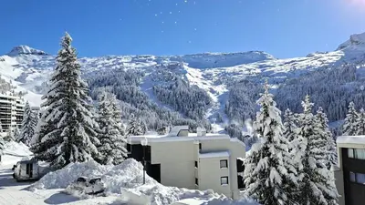 a snow covered mountain with trees and a building at Résidence Andromede - Studio rénové · Proche des pistes · Balcon · Casier à ski MAE-7411 in Flaine