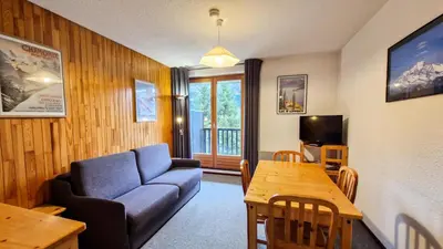 a living room with a couch and a table at Résidence Pollux - Studio confortable avec cabine · Proche des pistes et des commerces · Balcon MAE-7415 in Flaine