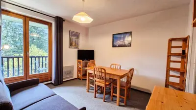 a living room with a table and a couch at Résidence Pollux - Studio confortable avec cabine · Proche des pistes et des commerces · Balcon MAE-7415 in Flaine