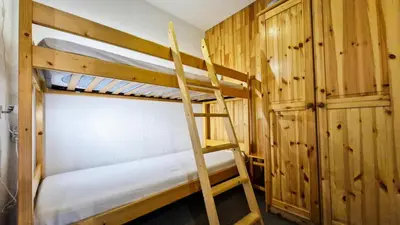 a bunk bed room with two bunk beds and a ladder at Résidence Pollux - Studio confortable avec cabine · Proche des pistes et des commerces · Balcon MAE-7415 in Flaine
