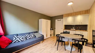 a living room with a blue couch and a table at Résidence Andromede - Studio confortable · Proche des pistes MAE-7416 in Flaine