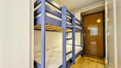 a blue bunk bed in a room with a door at Résidence Andromede - Studio confortable · Proche des pistes MAE-7416 in Flaine