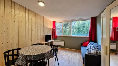 a living room with a table and a couch at Résidence Andromede - Studio confortable · Proche des pistes MAE-7416 in Flaine