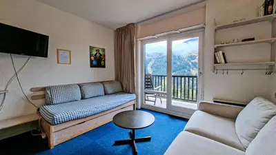 a living room with a couch and a balcony at Résidence Andromede - Studio lumineux · Proche des pistes · Balcon avec jolie vue MAE-7419 in Flaine