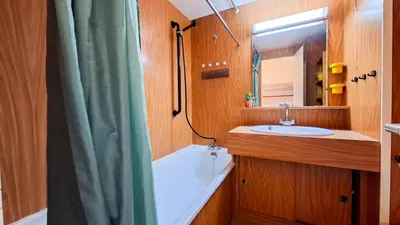 a bathroom with a shower curtain and a sink at Résidence Andromede - Studio lumineux · Proche des pistes · Balcon avec jolie vue MAE-7419 in Flaine