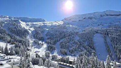 a snow covered mountain with trees and a resort at Résidence Andromede - Studio lumineux · Proche des pistes · Balcon avec jolie vue MAE-7419 in Flaine
