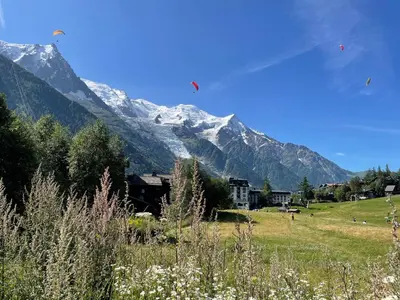 a group of kites flying in front of a mountain at Chalet Hôtel La Sapinière in Chamonix-Mont-Blanc
